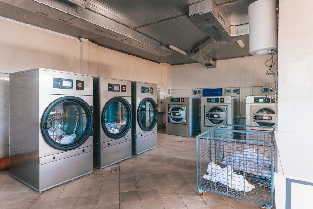 Commercial washer extractors used in a professional laundry business setup in India